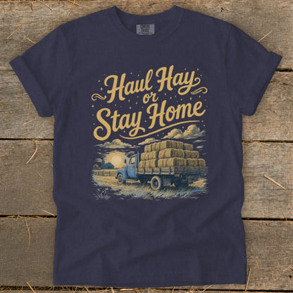 Dark blue t-shirt with "Haul Hay or Stay Home" text and a truck loaded with hay.