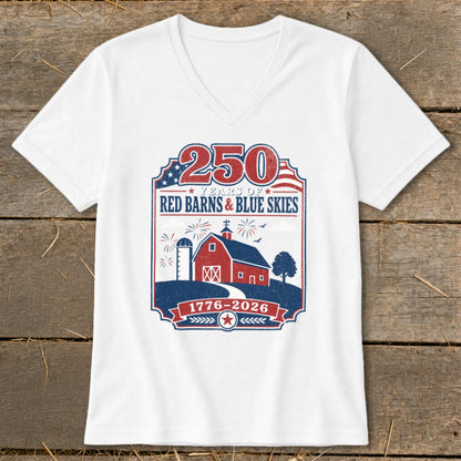 White V-neck t-shirt with patriotic "250 Years of Red Barns & Blue Skies 1776-2026" graphic.