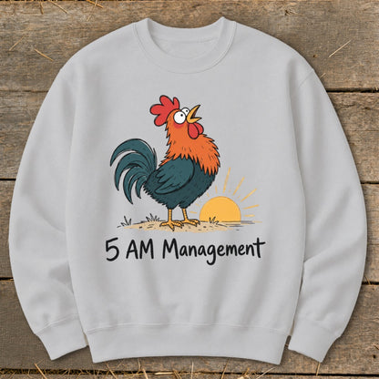 Light grey sweatshirt with cartoon rooster crowing at sunrise and text "5 AM Management".
