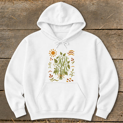White hoodie with embroidered sun, beanstalk, and autumn leaves design.
