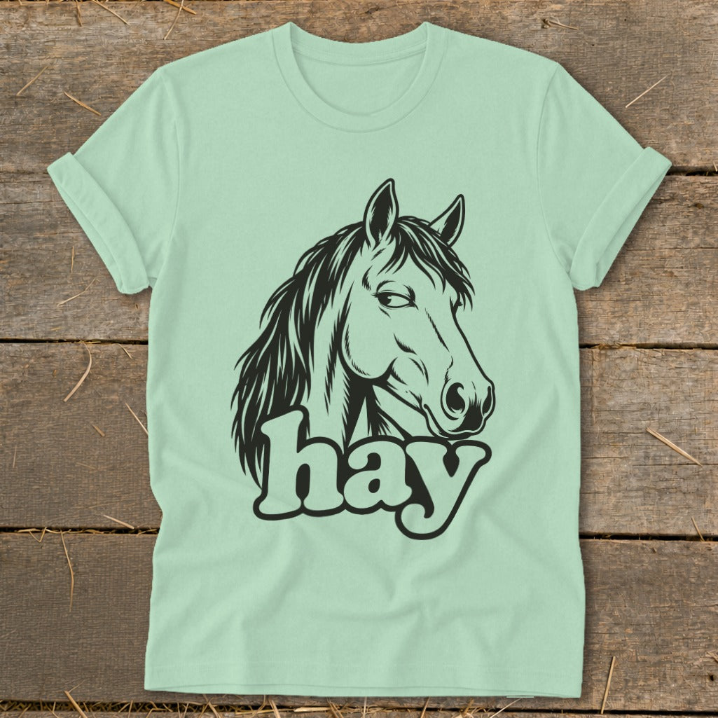 Light green t-shirt with black horse head graphic and "hay" text.