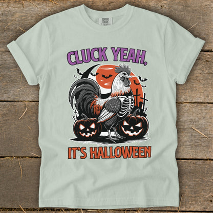 Rooster skeleton design with "CLUCK YEAH, IT'S HALLOWEEN" text and pumpkins.