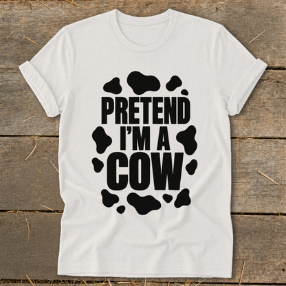 White t-shirt with black cow spots and text that reads "PRETEND I'M A COW".