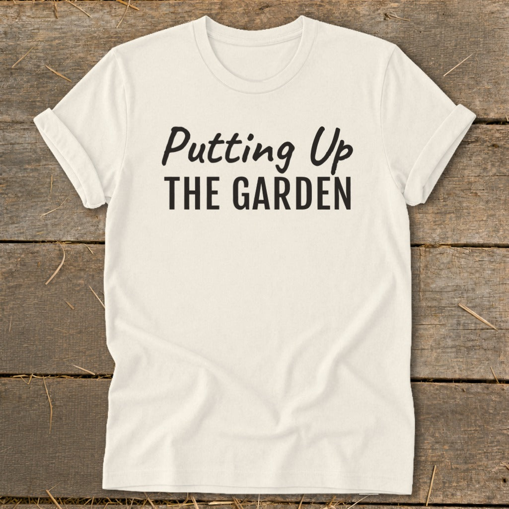 Cream t-shirt with black text reading "Putting Up THE GARDEN".