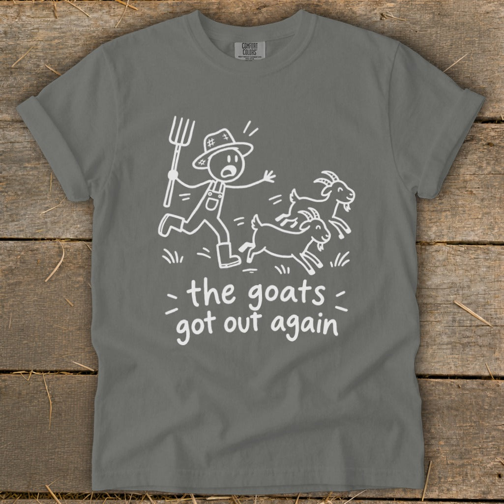Gray t-shirt with cartoon of farmer chasing goats, text reads "the goats got out again".