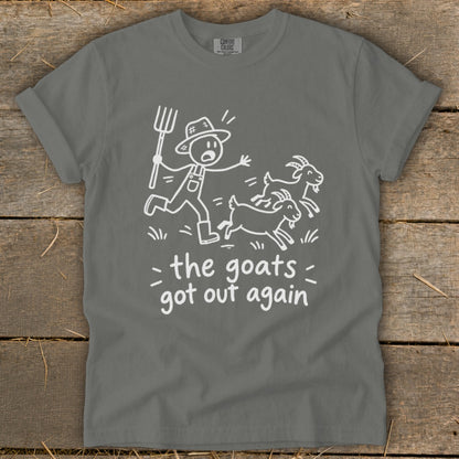 Gray t-shirt with cartoon of farmer chasing goats, text reads "the goats got out again".