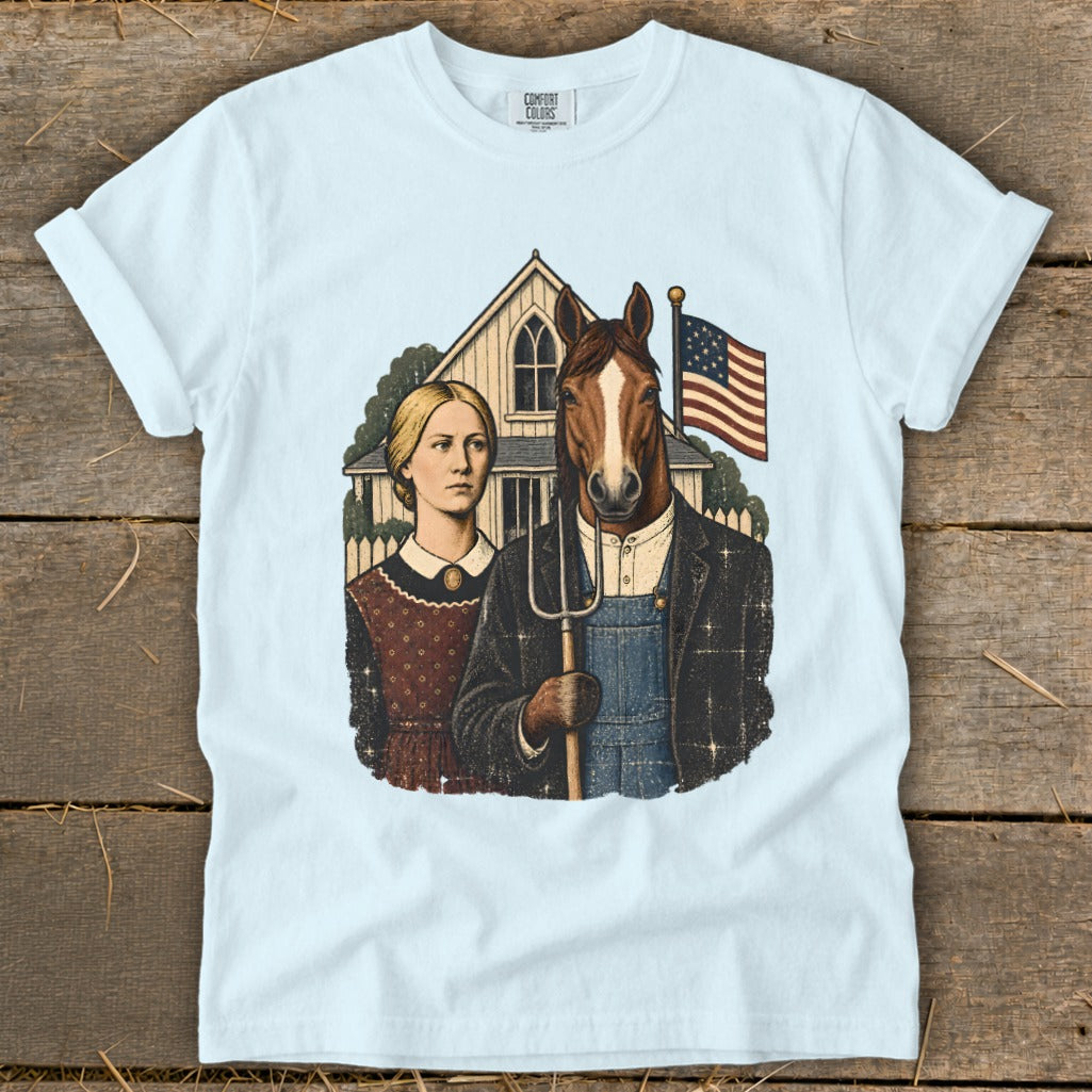 Light blue t-shirt featuring a parody of American Gothic with a woman and a horse holding a pitchfork.