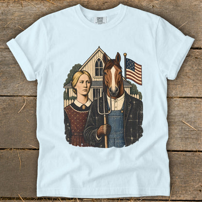Light blue t-shirt featuring a parody of American Gothic with a woman and a horse holding a pitchfork.