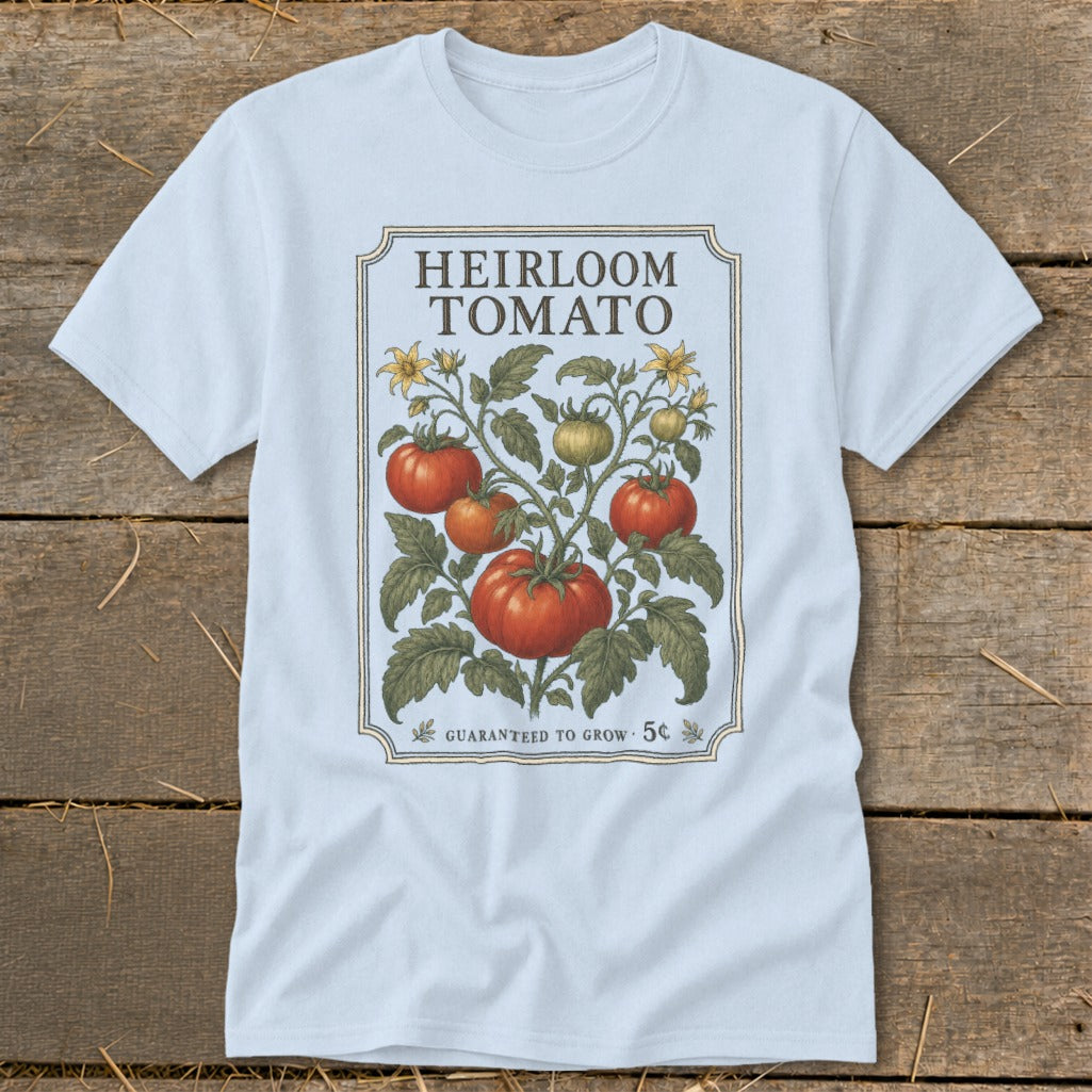 Light blue t-shirt with vintage "Heirloom Tomato" design featuring tomatoes, leaves, and flowers.