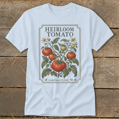 Light blue t-shirt with vintage "Heirloom Tomato" design featuring tomatoes, leaves, and flowers.
