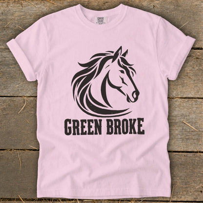 Light pink t-shirt featuring a black horse head graphic and the text GREEN BROKE.