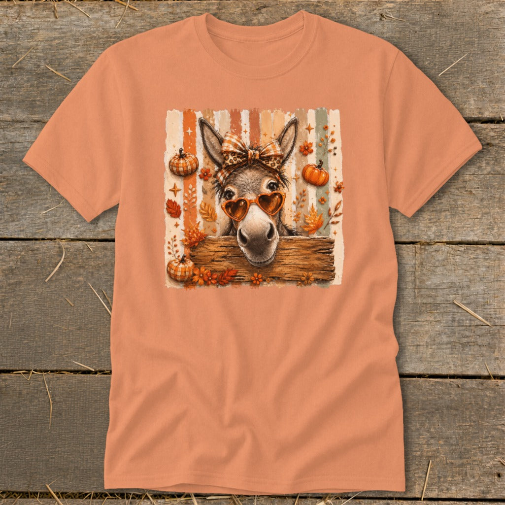 Donkey wearing heart sunglasses and bow tie with pumpkins and autumn leaves.