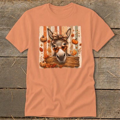 Donkey wearing heart sunglasses and bow tie with pumpkins and autumn leaves.