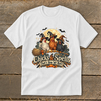 Three witch-hatted chickens fly on a broomstick under a full moon, with text "Chicks & Spells".