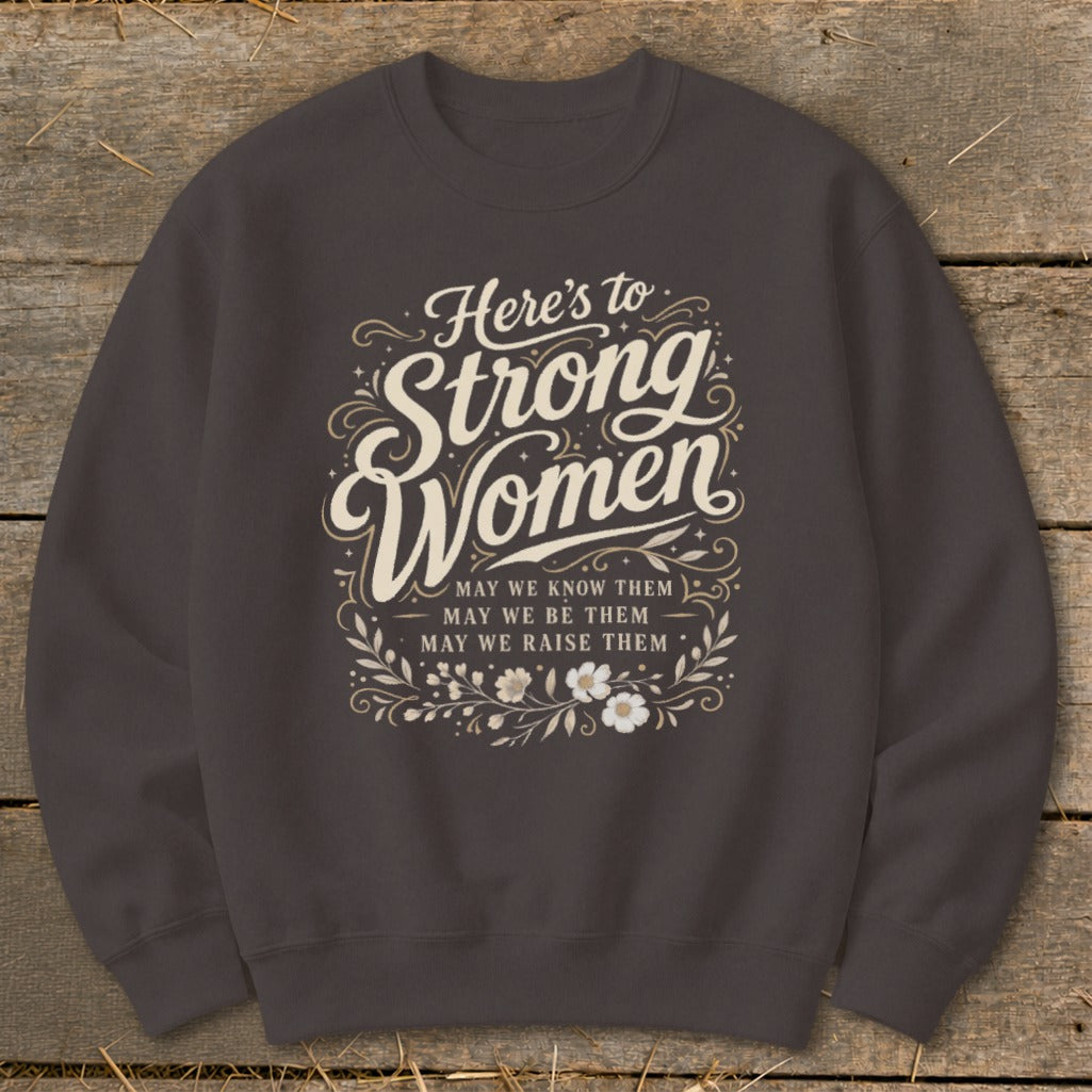 Dark gray sweatshirt with "Here's to Strong Women" text and floral design.