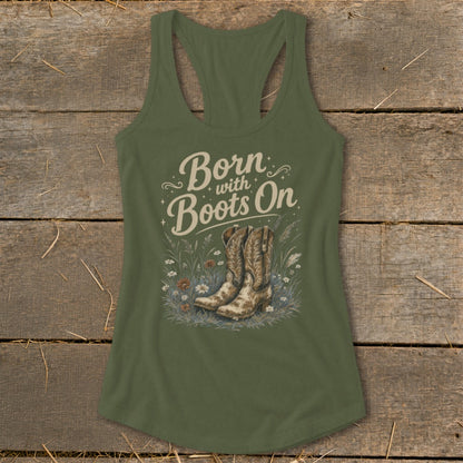 Olive green tank top with "Born with Boots On" text and cowboy boots in grass.