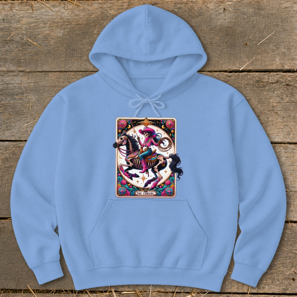 Light blue hoodie featuring a "The Cowgirl" graphic of a skeleton riding a horse with lasso and pink accents.