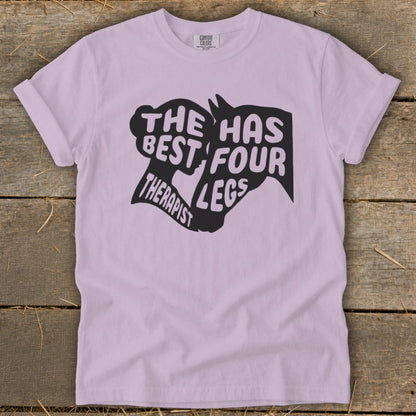 Light purple t-shirt with "The Best Therapist Has Four Legs" text and horse silhouette graphic.