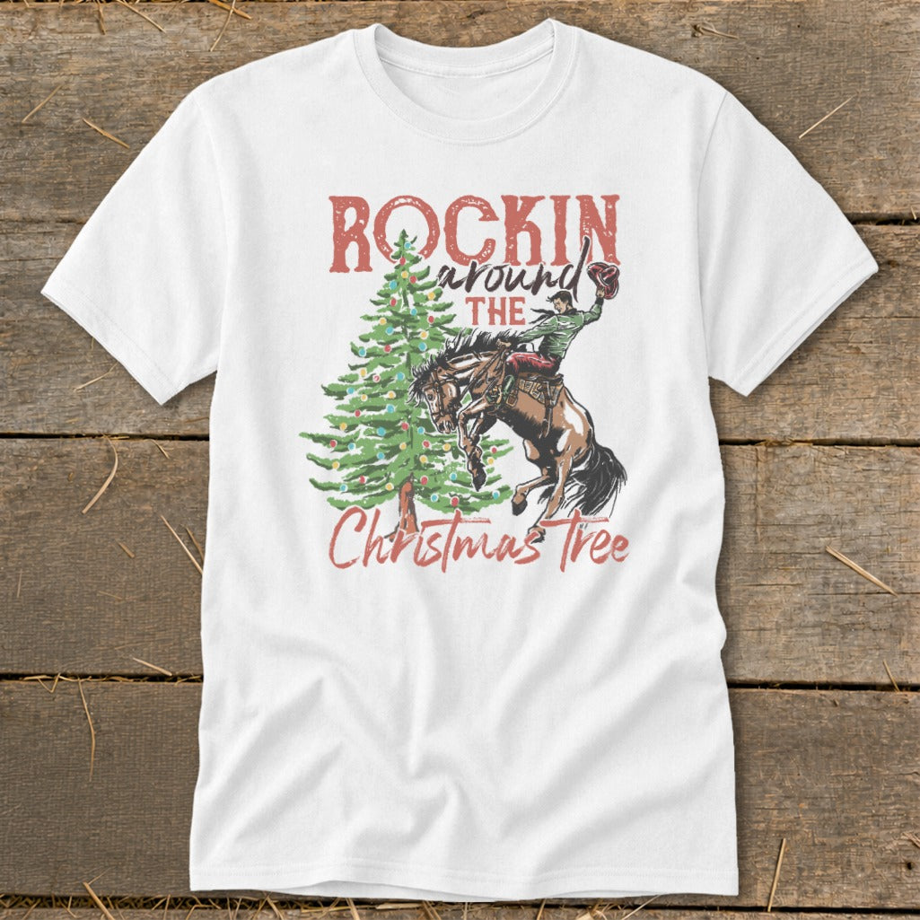 White t-shirt with "Rockin around the Christmas Tree" text and cowboy on bucking horse.