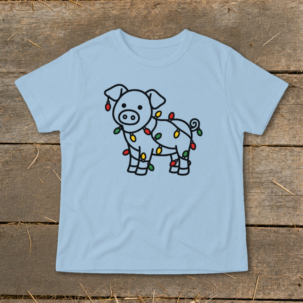 Light blue t-shirt featuring a line drawing of a pig tangled in colorful Christmas lights.