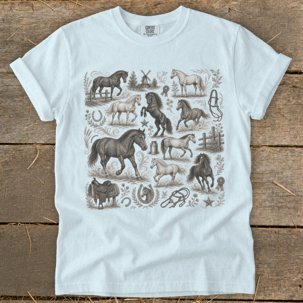 White t-shirt with vintage equine illustrations including horses, saddle, horseshoe, and windmill.