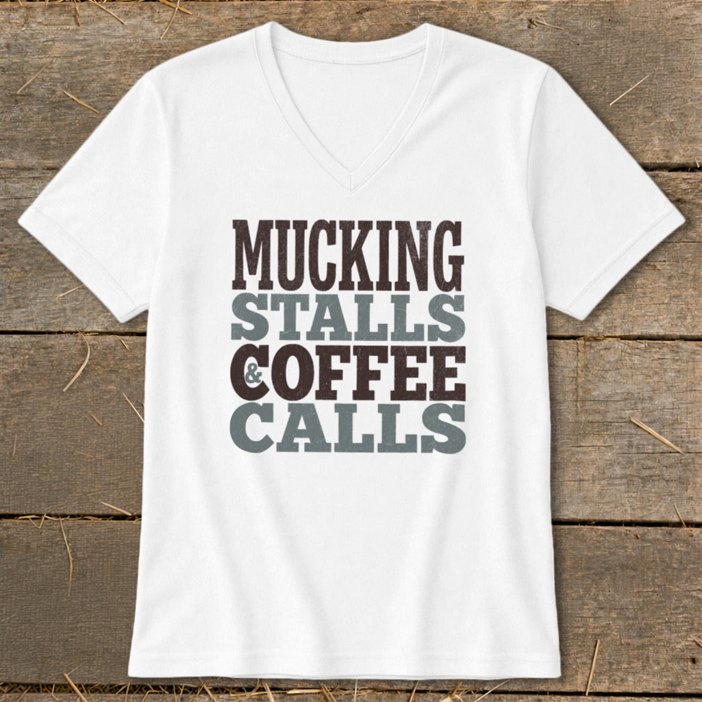 White v-neck t-shirt with "Mucking Stalls Coffee Calls" graphic.