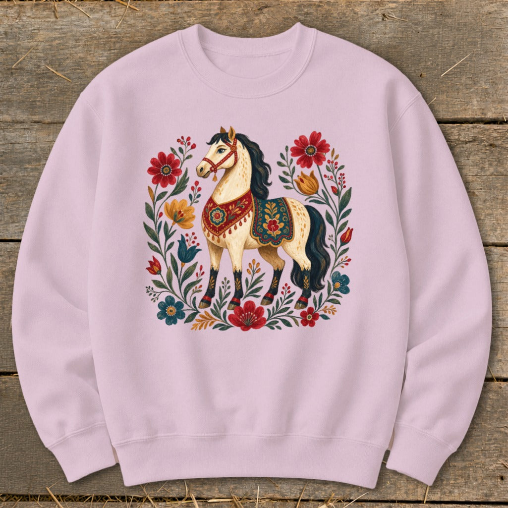 Light pink sweatshirt with a stylized horse surrounded by colorful folk art flowers.