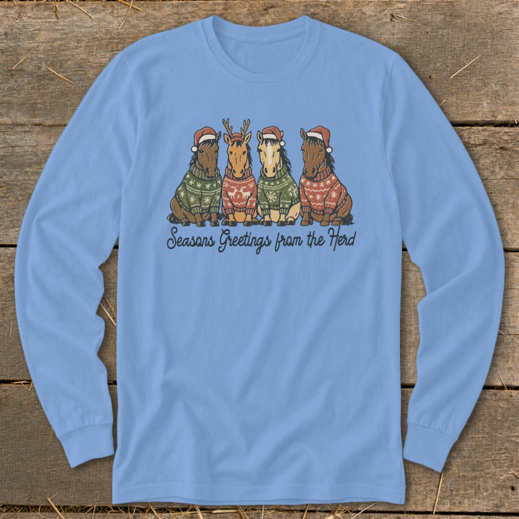 Four horses wearing Santa hats and sweaters sit in a row, with text reading "Seasons Greetings from the Herd".