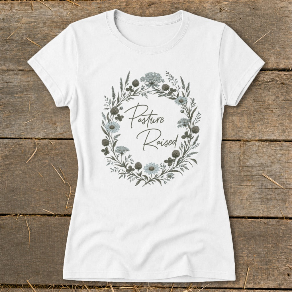 White t-shirt with a circular floral design and "Pasture Raised" text.