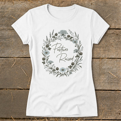 White t-shirt with a circular floral design and "Pasture Raised" text.