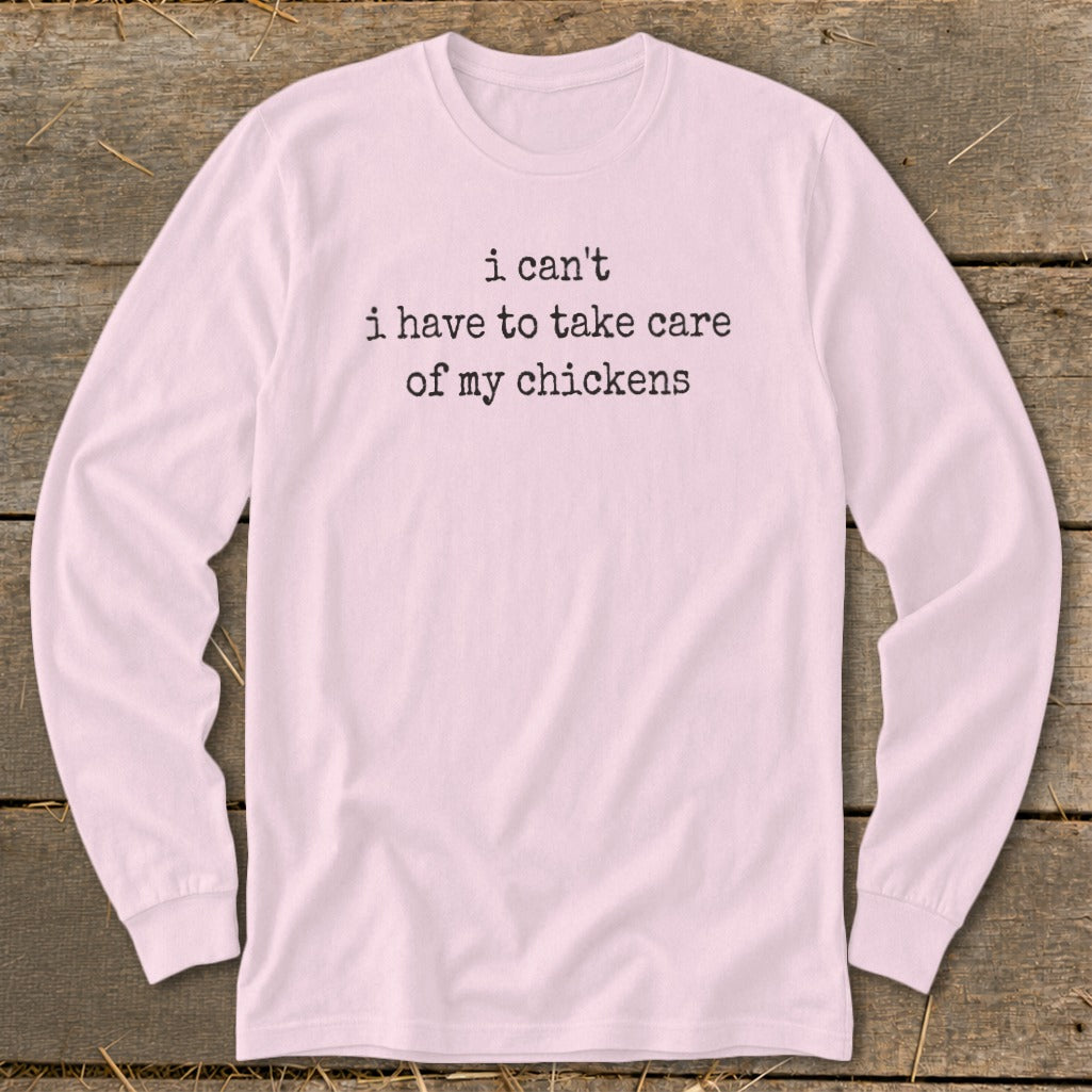 Pink long-sleeved shirt with black text: I can't I have to take care of my chickens.