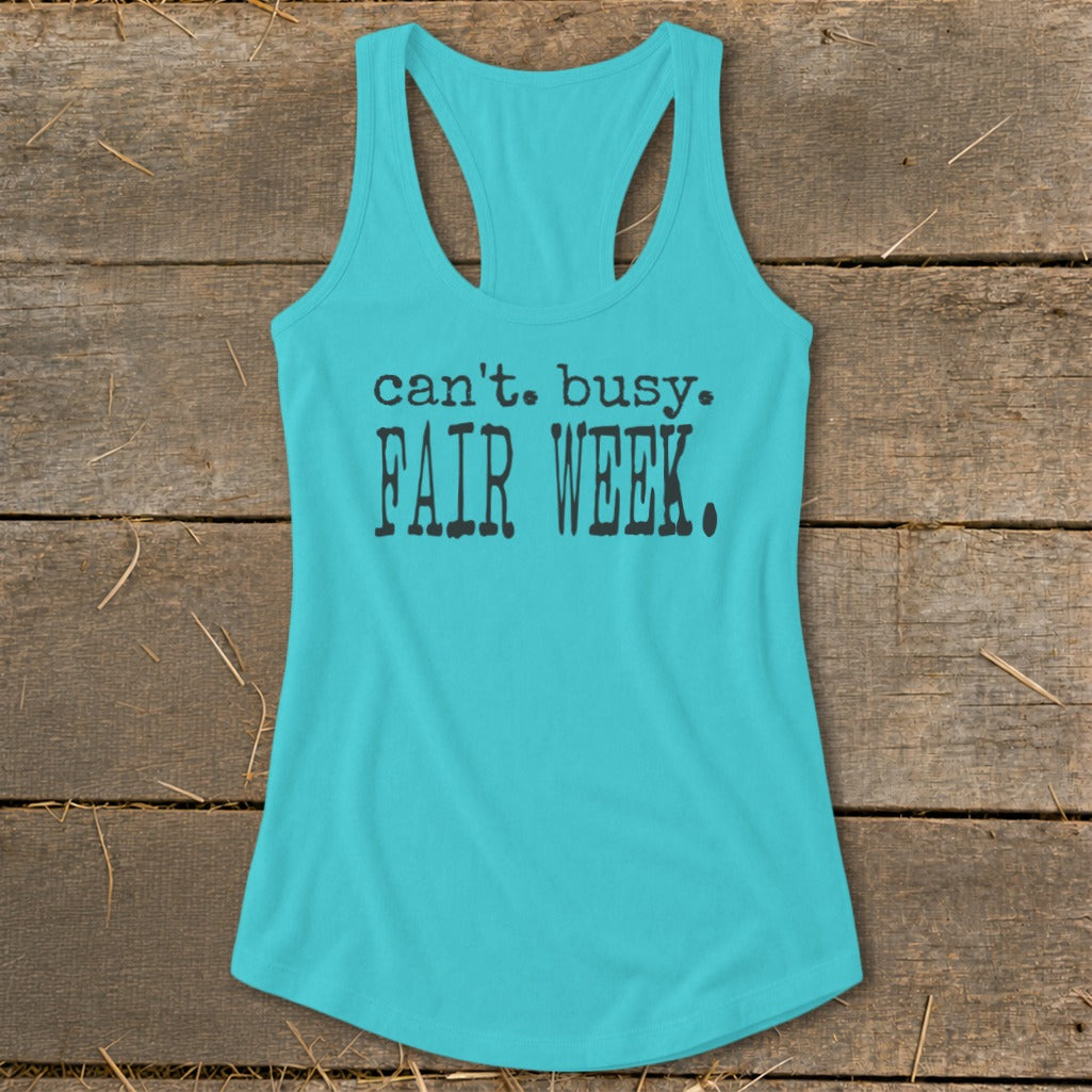 Turquoise racerback tank top with black text that reads "can't. busy. FAIR WEEK."