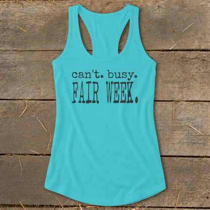 Turquoise racerback tank top with black text that reads "can't. busy. FAIR WEEK."