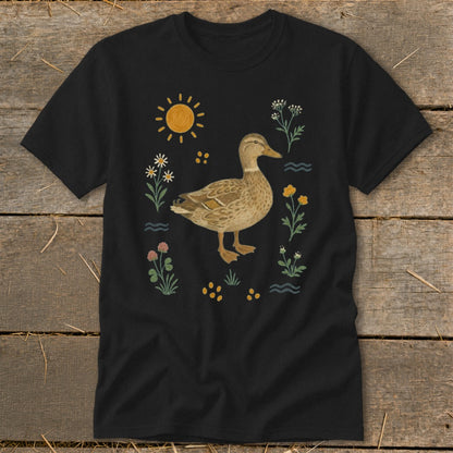 Black t-shirt with a duck surrounded by wildflowers and a sun illustration.