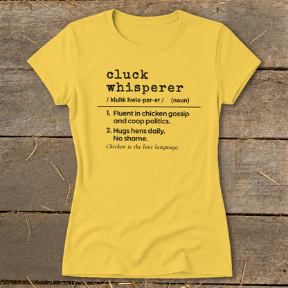 Yellow t-shirt with "cluck whisperer" definition: fluent in chicken gossip, hugs hens.