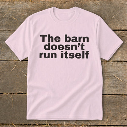 Pink t-shirt with black text reading "The barn doesn't run itself".