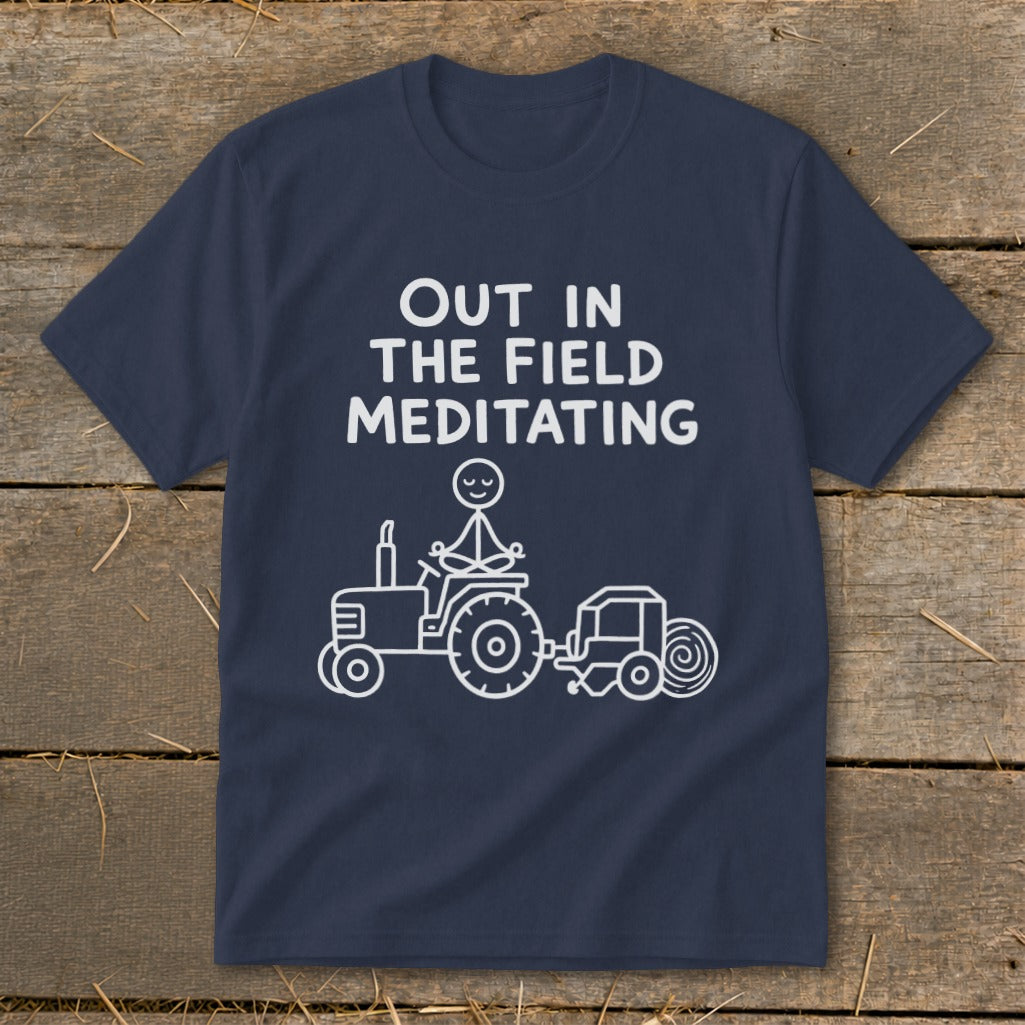 Navy t-shirt with white text and a line drawing of a stick figure meditating on a tractor.