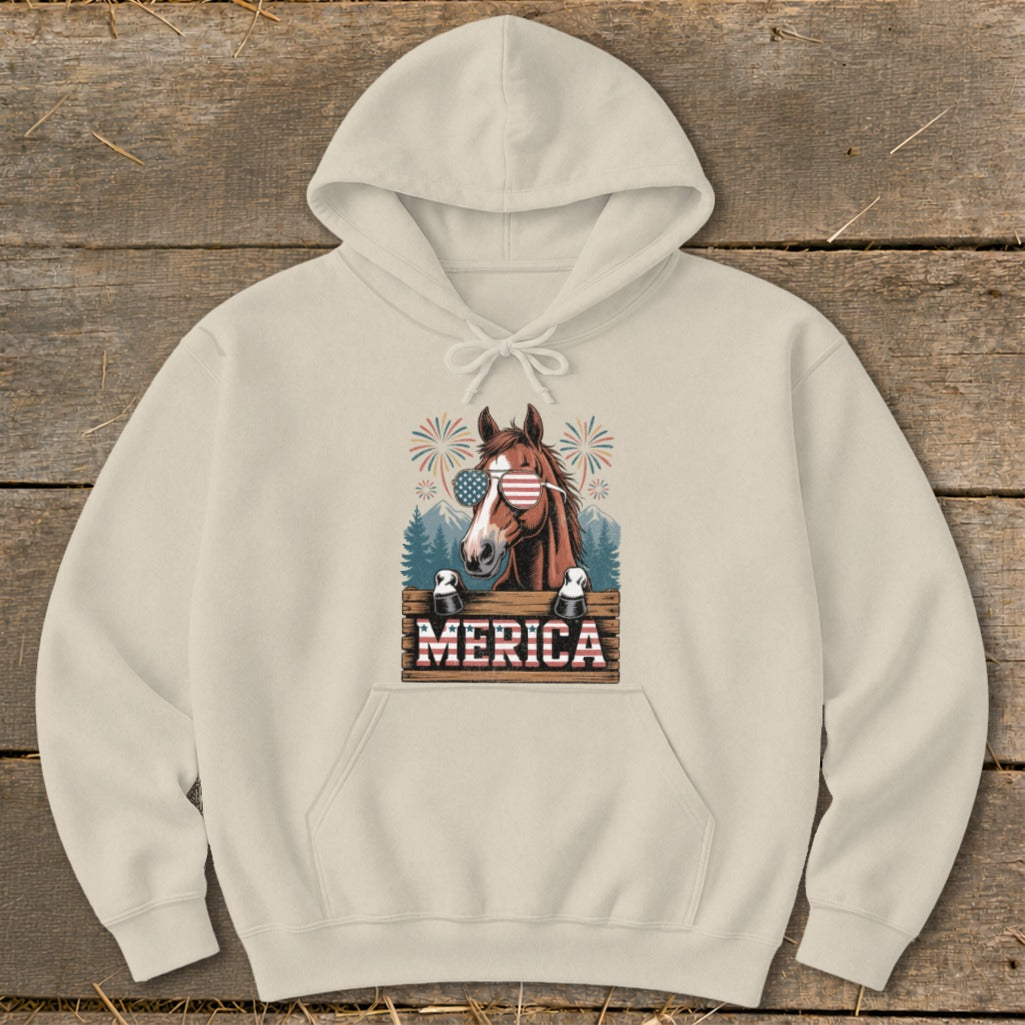 Horse with American flag sunglasses and "MERICA" text on a beige hoodie.