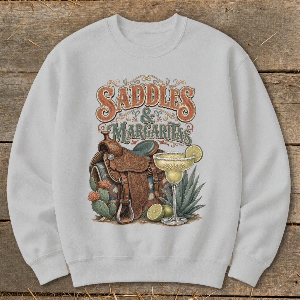 Graphic on sweatshirt: "Saddles & Margaritas" with saddle, margarita, and cacti.