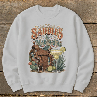 Graphic on sweatshirt: "Saddles & Margaritas" with saddle, margarita, and cacti.