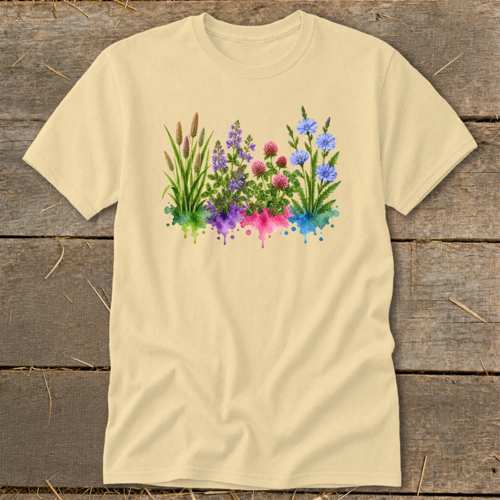 A light yellow t-shirt with a chest graphic of watercolor wildflowers over colorful paint splatters.