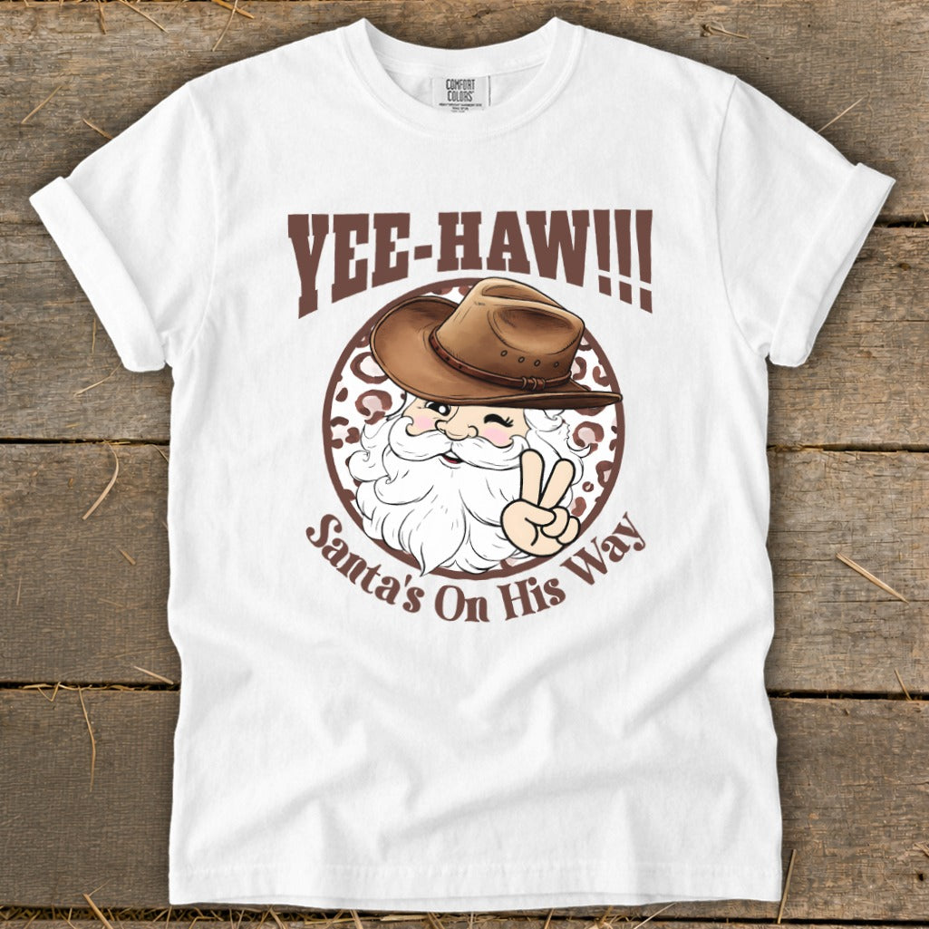 White t-shirt with "Yee-Haw!!!" and Santa in a cowboy hat with peace sign.