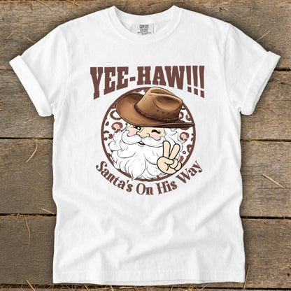 White t-shirt with "Yee-Haw!!!" and Santa in a cowboy hat with peace sign.