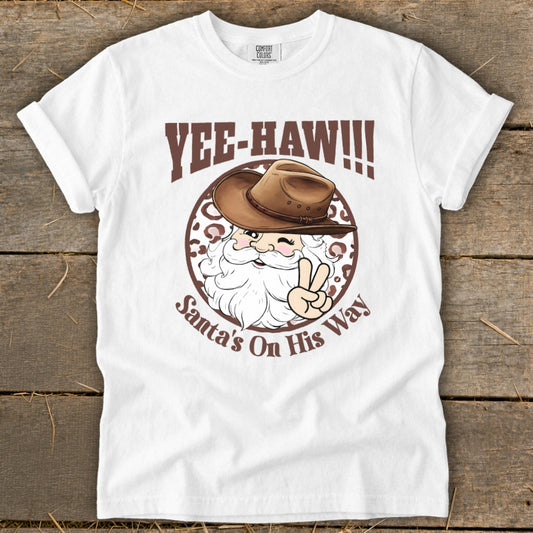 White t-shirt with "Yee-Haw!!!" and Santa in a cowboy hat with peace sign.