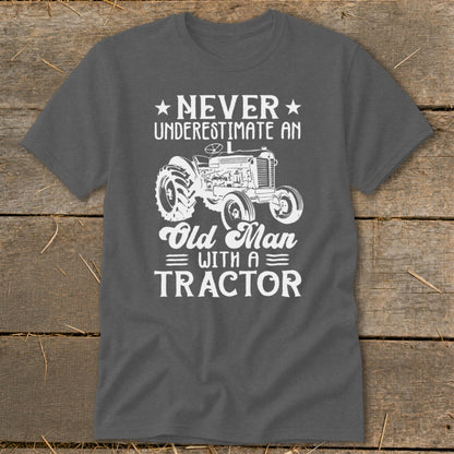 Gray t-shirt with white text and tractor graphic saying "Never Underestimate an Old Man with a Tractor".