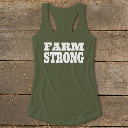 Olive green racerback tank top with the white distressed text FARM STRONG on a wooden background.
