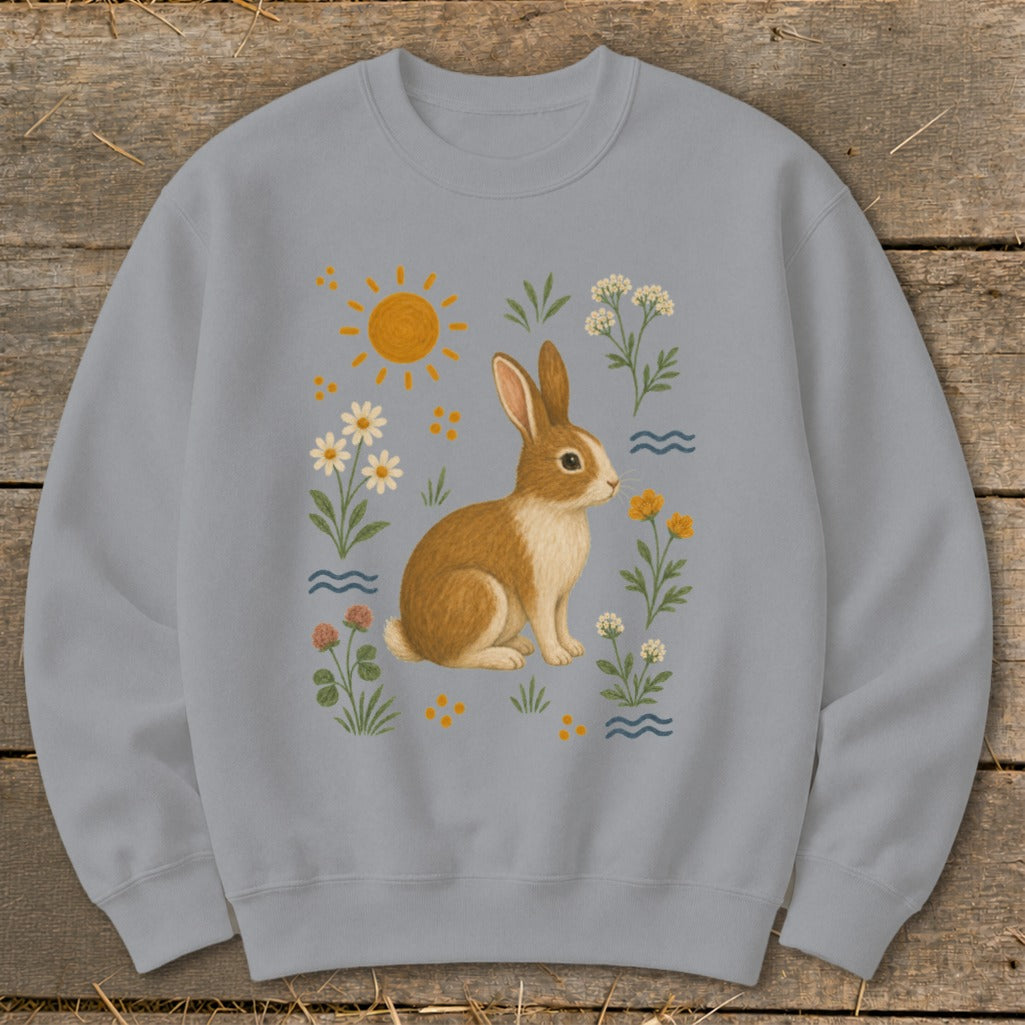 Gray sweatshirt with a brown and white rabbit surrounded by flowers and a sun.