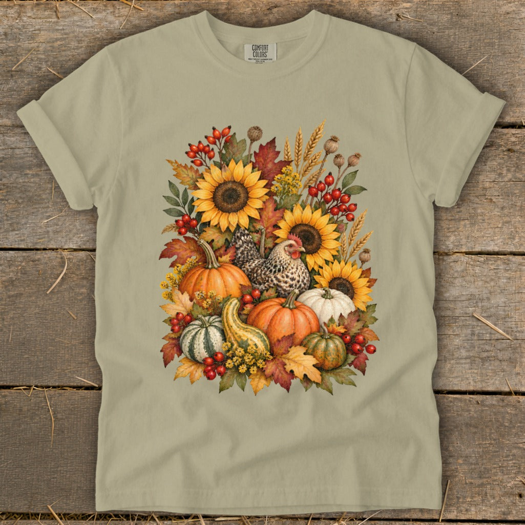T-shirt with a watercolor design of sunflowers, pumpkins, gourds, chicken, and autumn leaves.