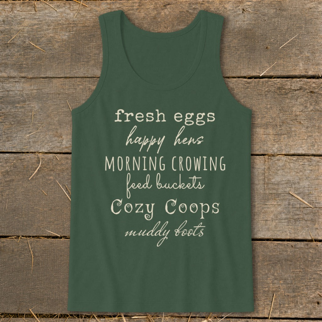 Green tank top with text: fresh eggs, happy hens, morning crowing, feed buckets, cozy coops, muddy boots.