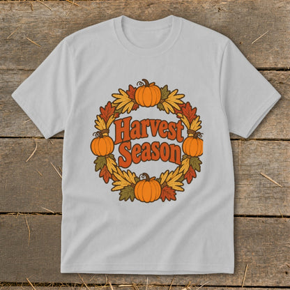 Light gray t-shirt with "Harvest Season" text within a circular wreath of pumpkins and autumn leaves.